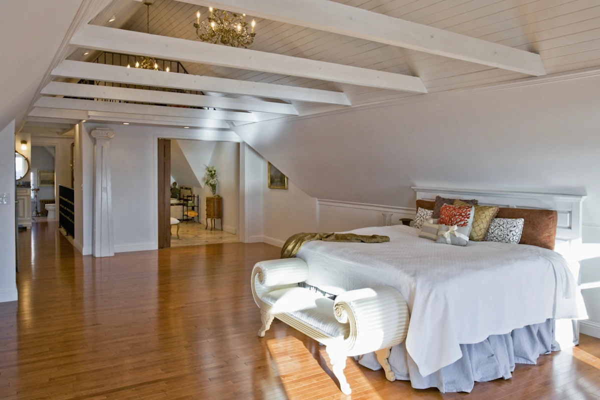 Une grande chambre avec des poutres apparentes