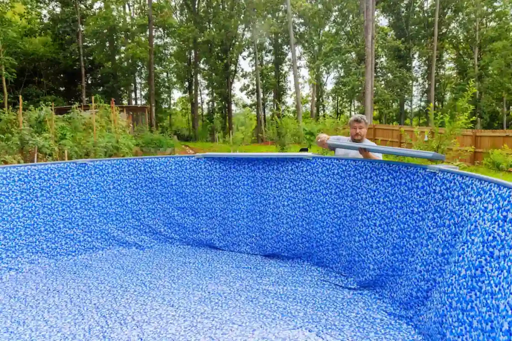 Une personne qui change un liner piscine